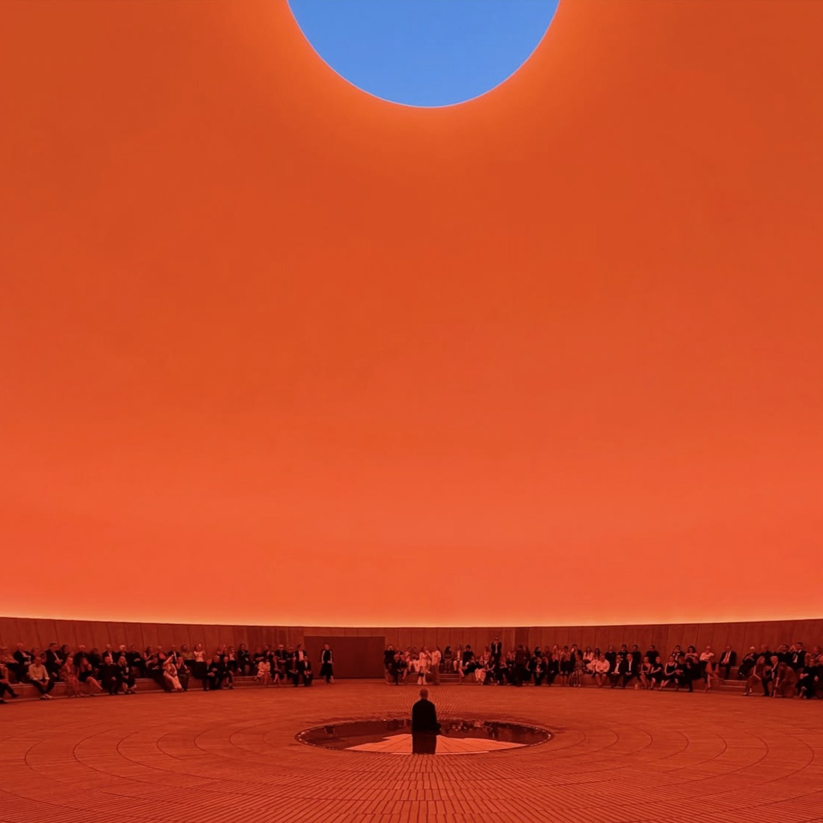 Circular orange room with a round skylight opening to blue sky